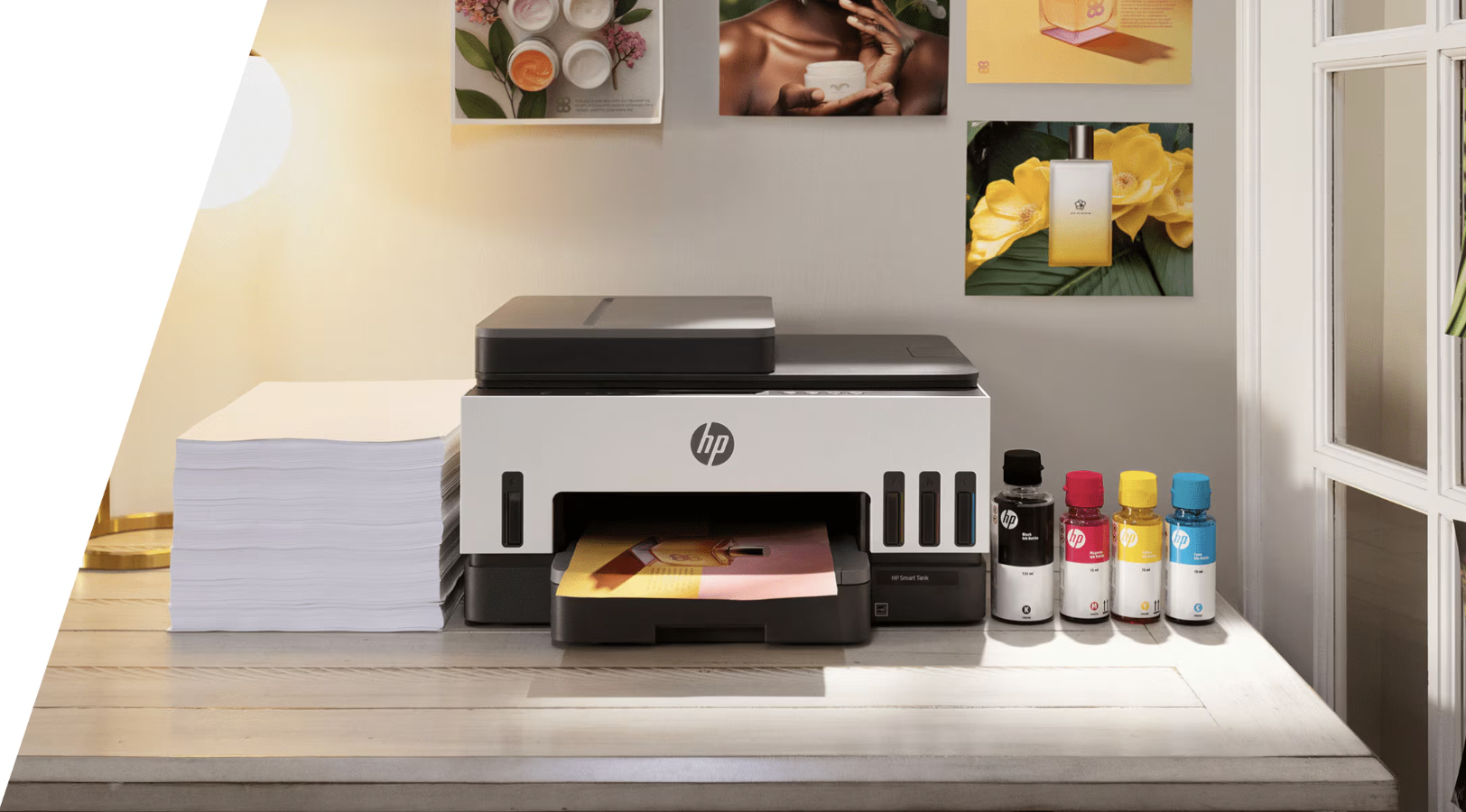 HP printer with ink bottles on a desk